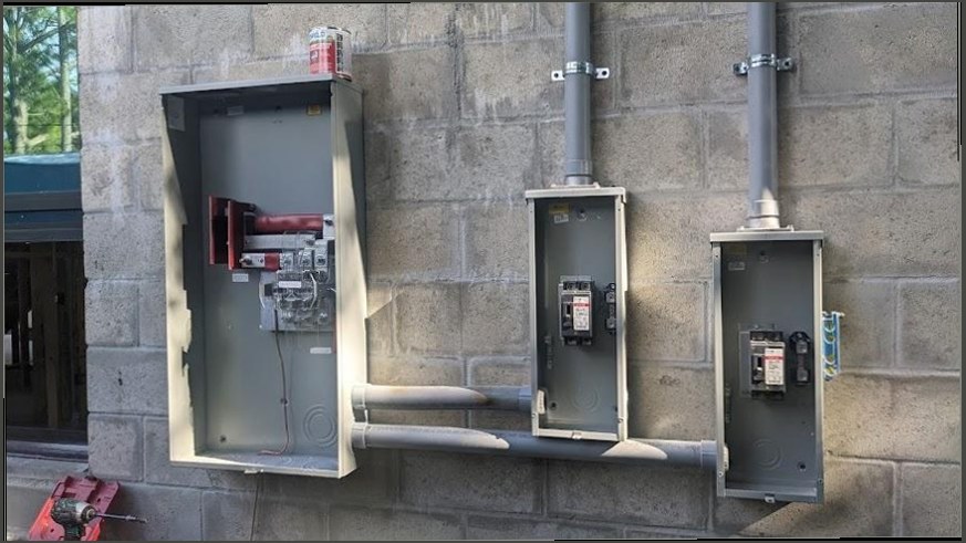Exterior meter base, disconnect and sub panels part way through installation